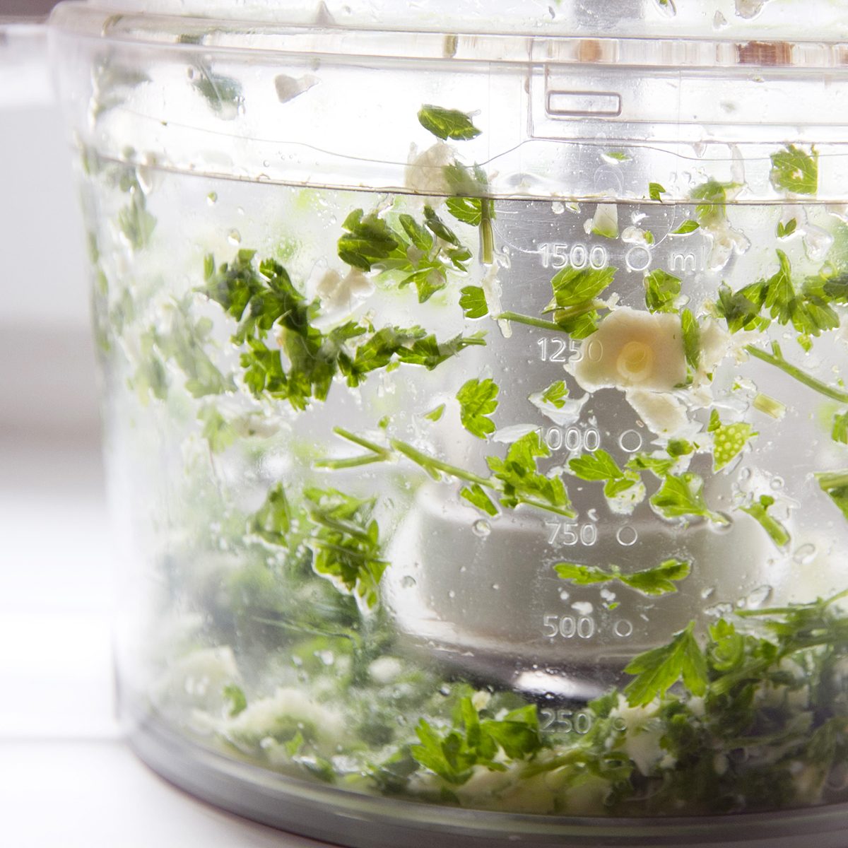 Blending herbs in food processor; Shutterstock ID 1170676570; Job (TFH, TOH, RD, BNB, CWM, CM): TOH