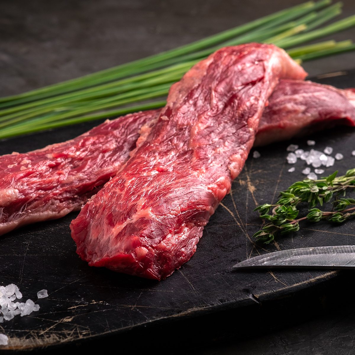two Flap Steaks with seasonings and vegetables