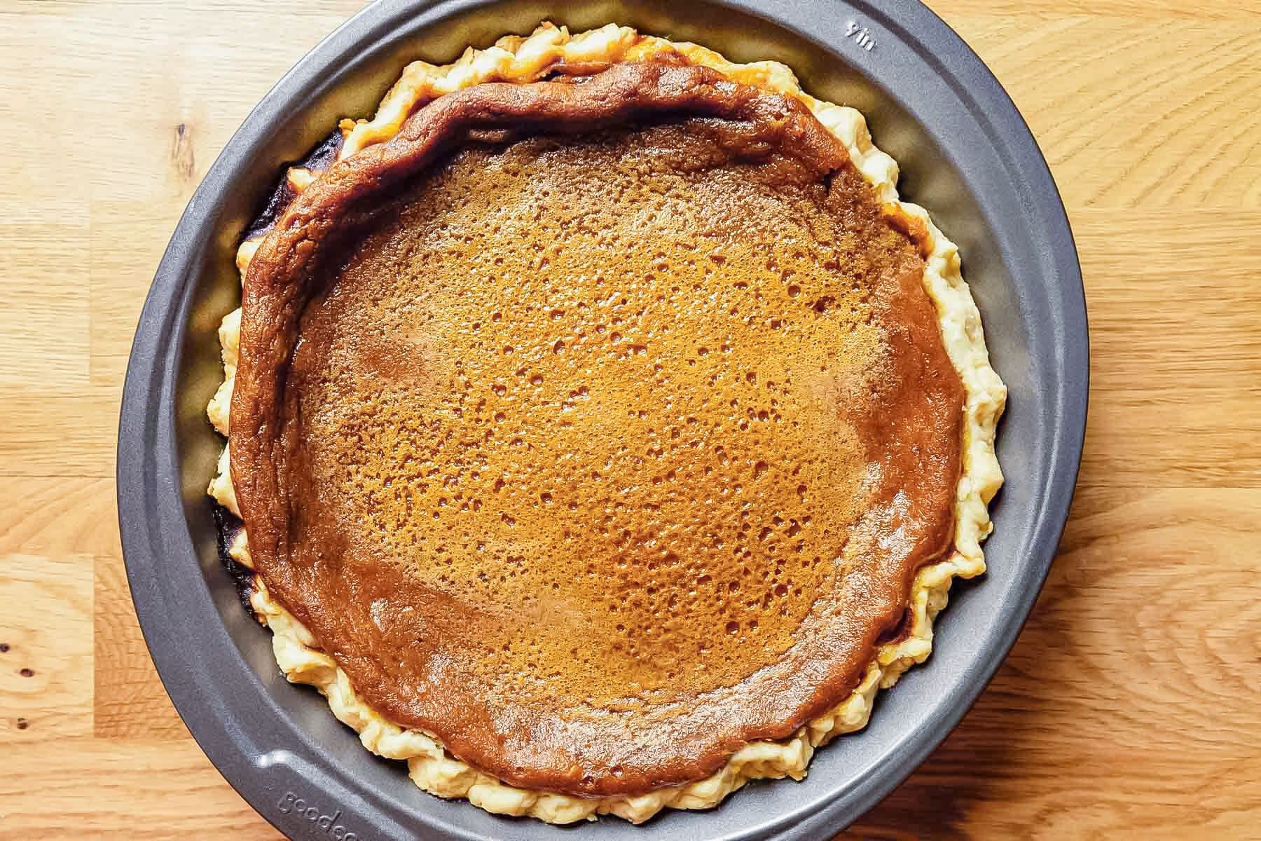 Dairy Free Pumpkin Pie in a Baking Plate on Wooden Surface