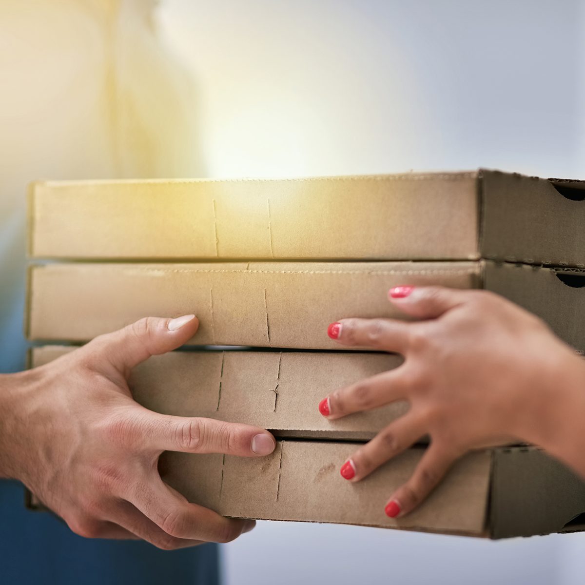 Shot of an unidentifiable businesswoman accepting a pizza delivery from a delivery man in the office