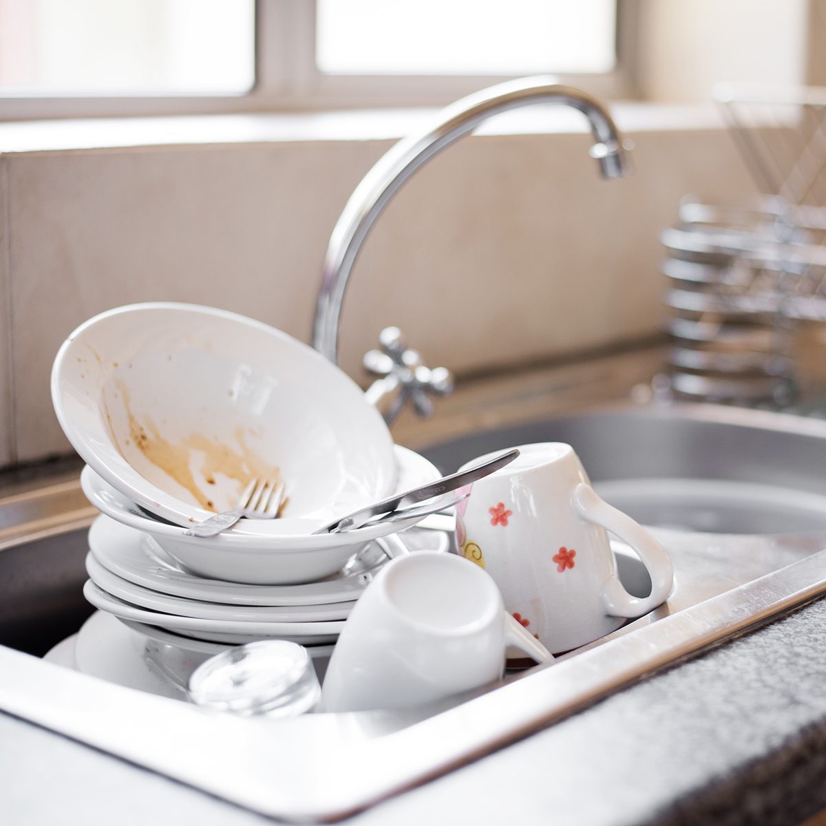 Shot of kitchen sink full of dirty dishes
