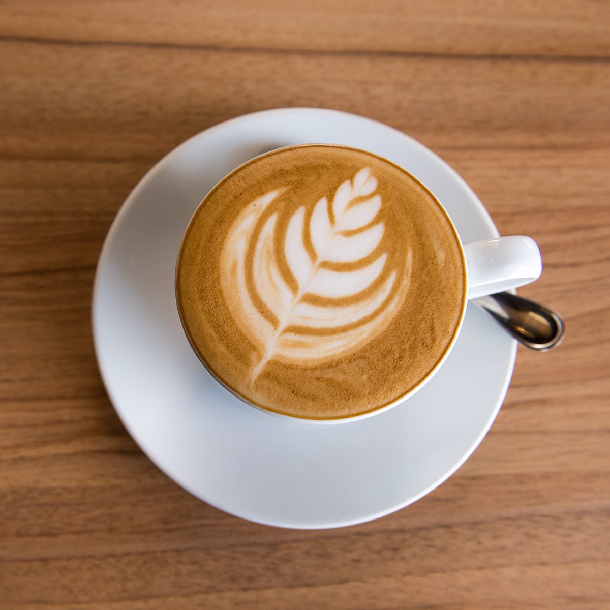 Flat white coffee on wooden table, Top view