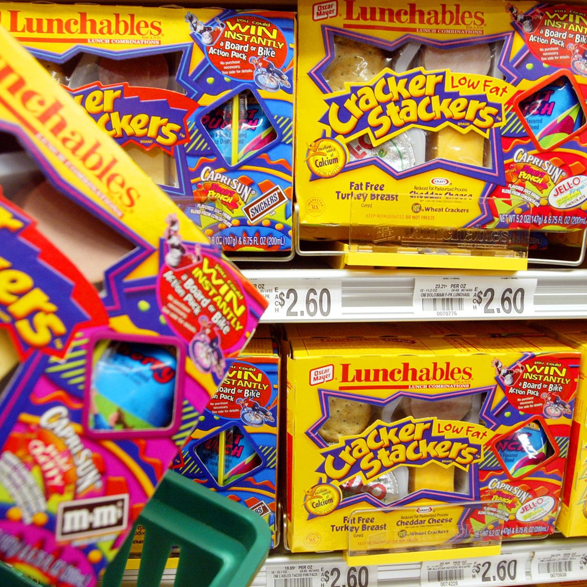MIAMI - JULY 1: A shopper picks an Oscar Mayer Lunchables product from a store shelf July 1, 2003 in Miami, Florida. Kraft Foods Inc., the nations largest food manufacturer and the maker of Oscar Mayer meats, plans to examine the nutrition of its products and take steps to fight obesity and promote health. (Photo by Joe Raedle/Getty Images)
