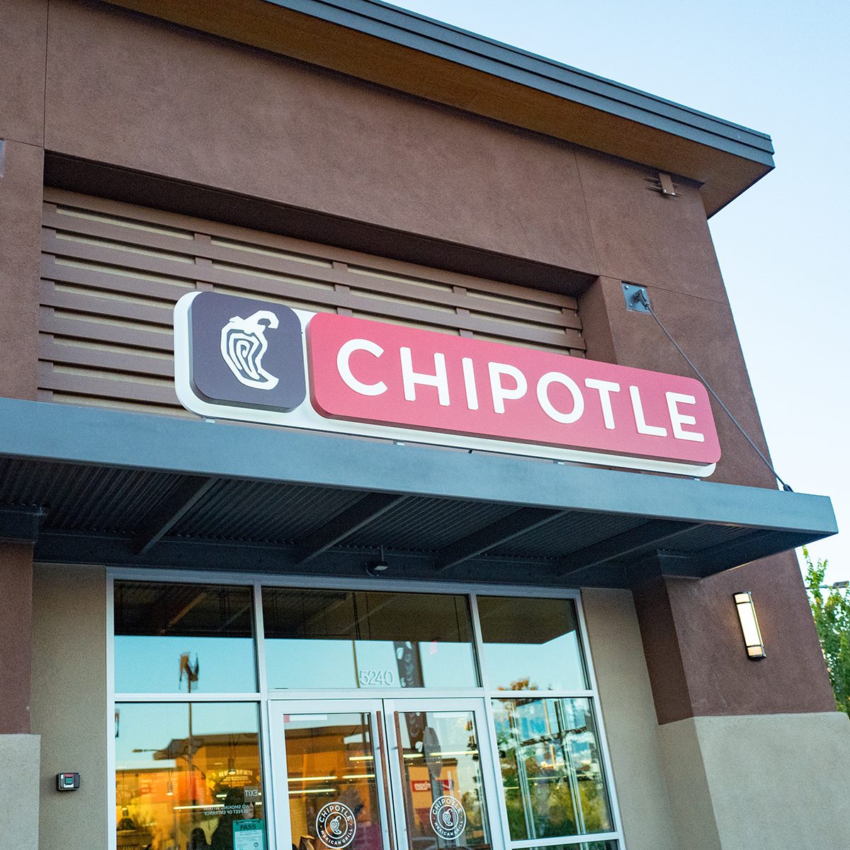 Facade with signage at a local franchise of the Chipotle chain of Mexican restaurants, Dublin, California, July 10, 2017. (Photo by Smith Collection/Gado/Getty Images)