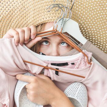 Woman organizing clothes from a small closet