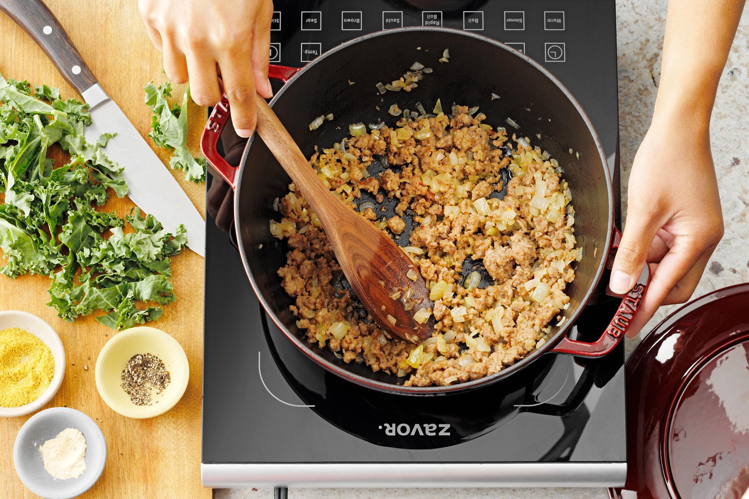 browning sausage and sauted onions in the bottom of a large soup pot