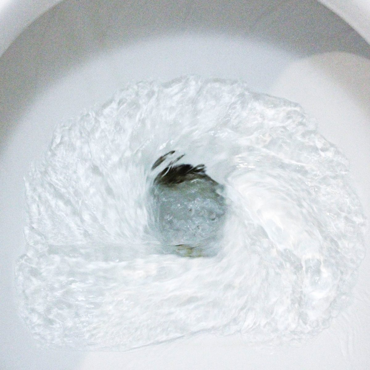 selective focus close up flushing toilet bowl for sanitary
