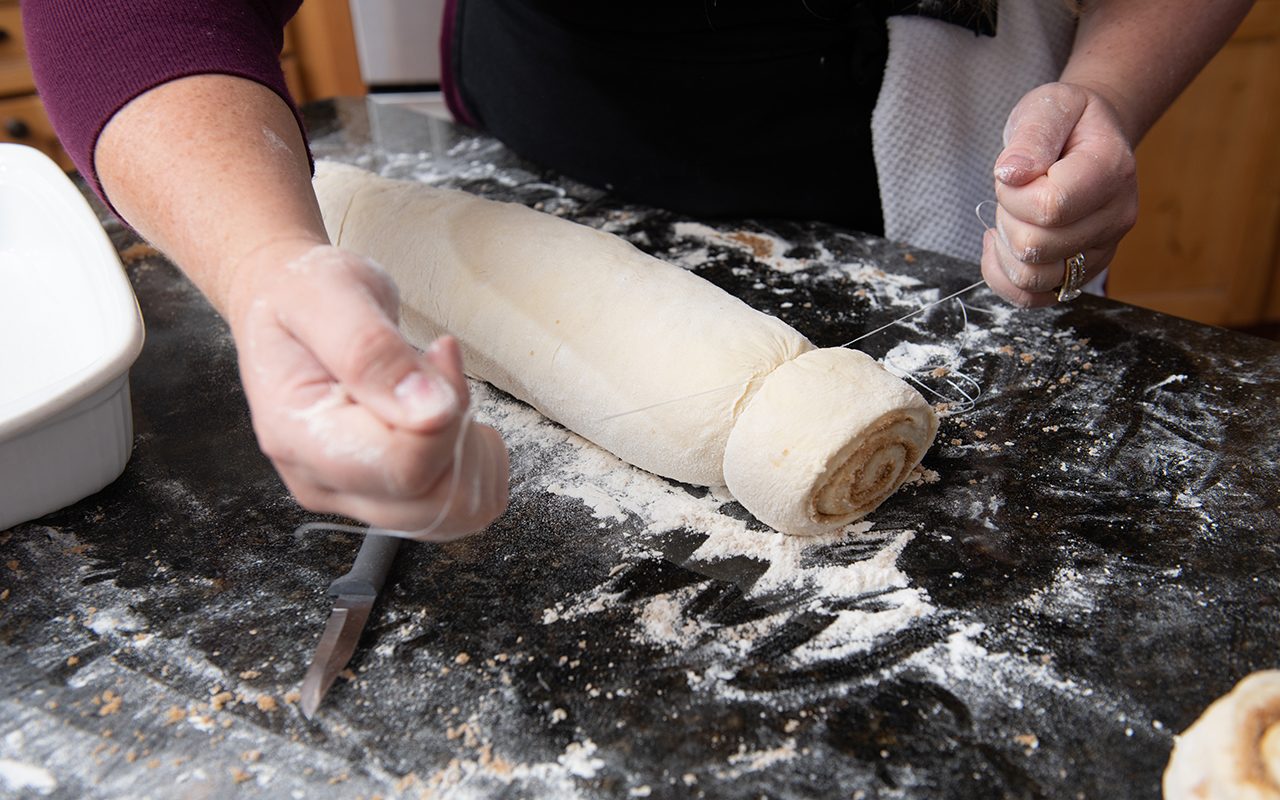 Cristen Clark cutting individual slices from the main roll