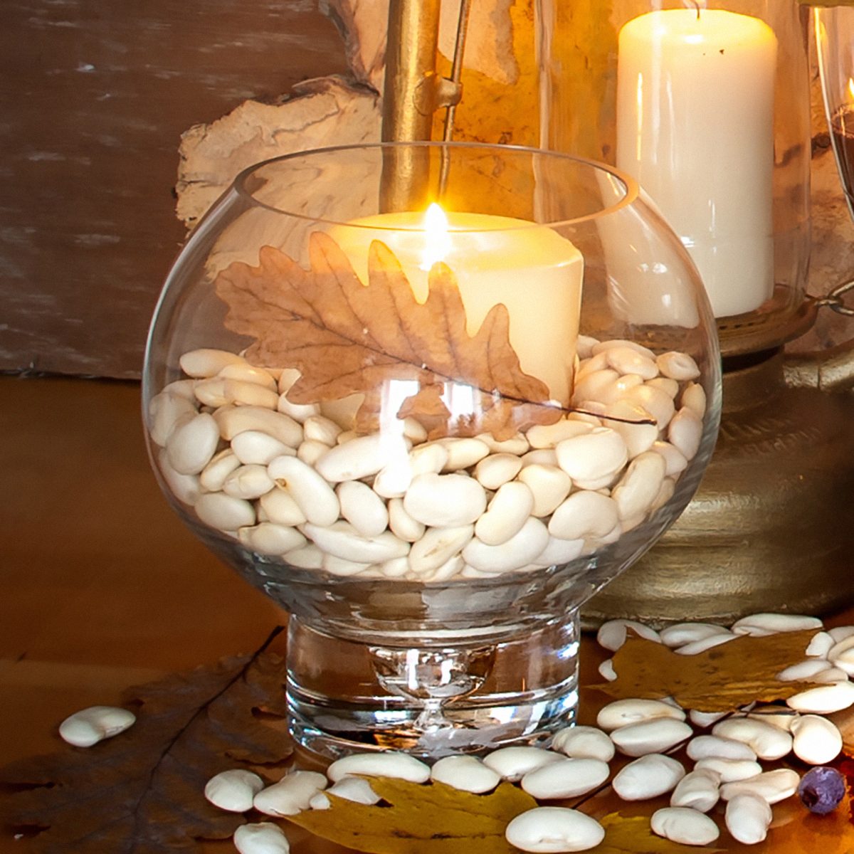 Thanksgiving Day decoration with candles, fruits, vegetables and glass of wine