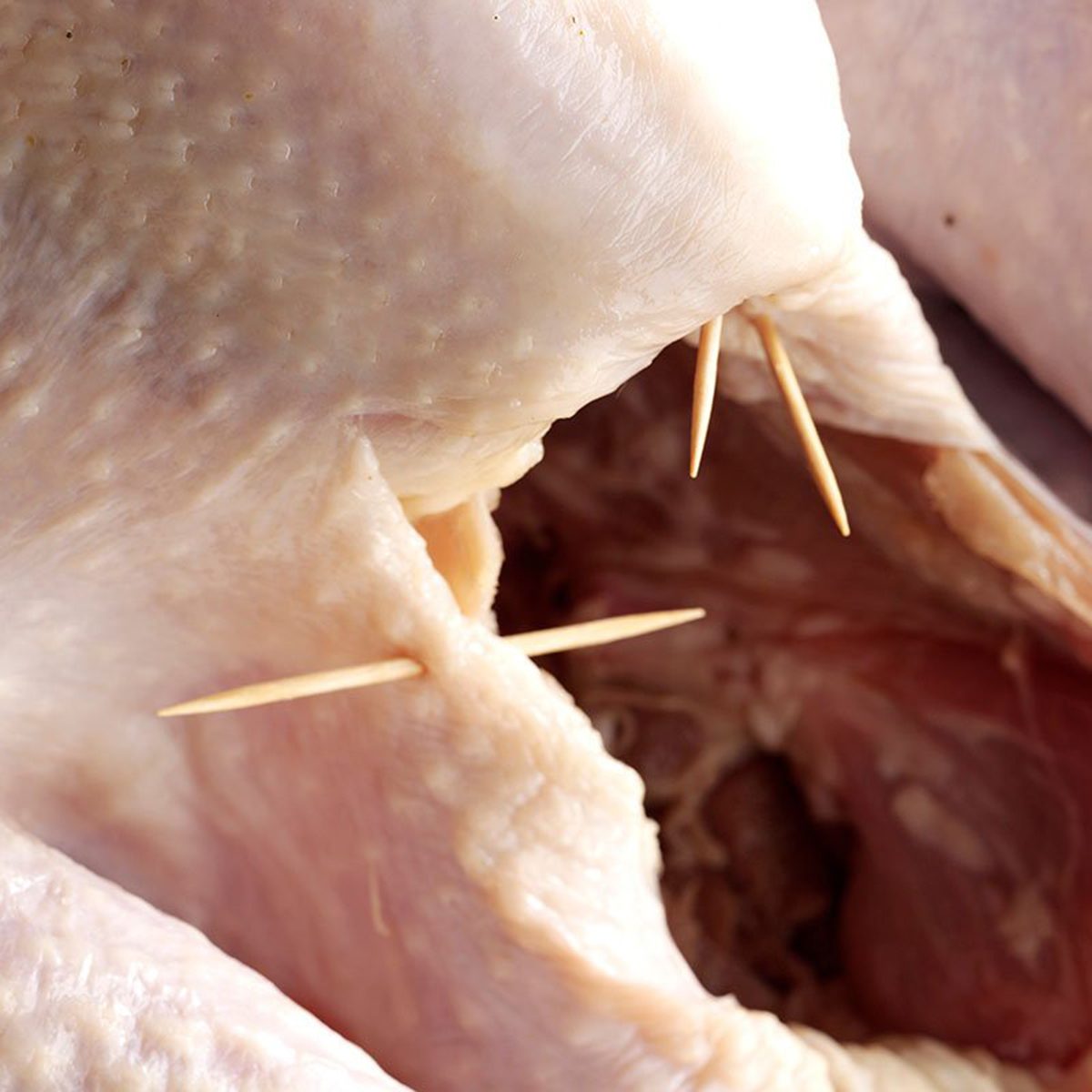 Toothpicks in raw turkey skin