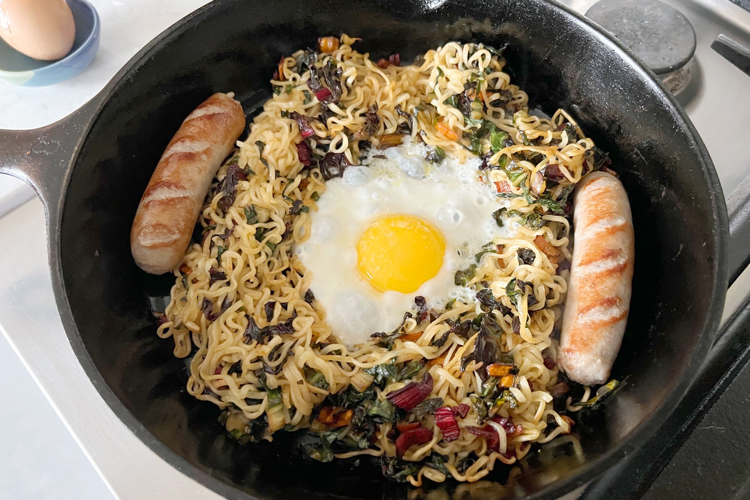 making breakfast Ramen in a cast iron skillet
