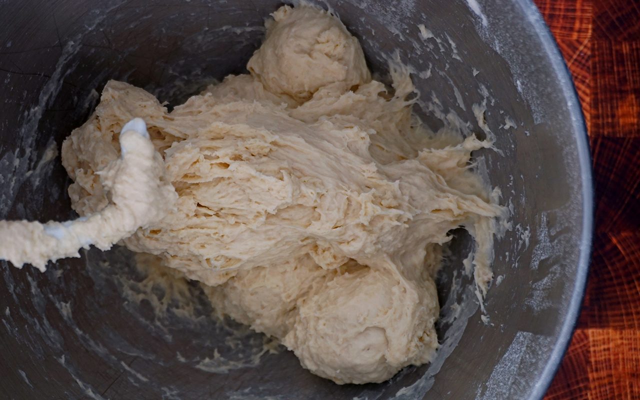 mixing bread bowl ingredients until soft, sticky dough forms copycat panera bread bowl