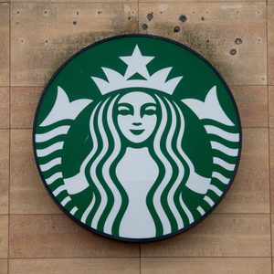 Starbucks logo Sign on wood paneled wall
