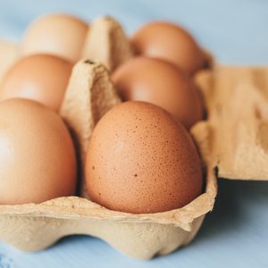 Eggs Background Closeup View Of Eggs In Carton Box On Wooden Table