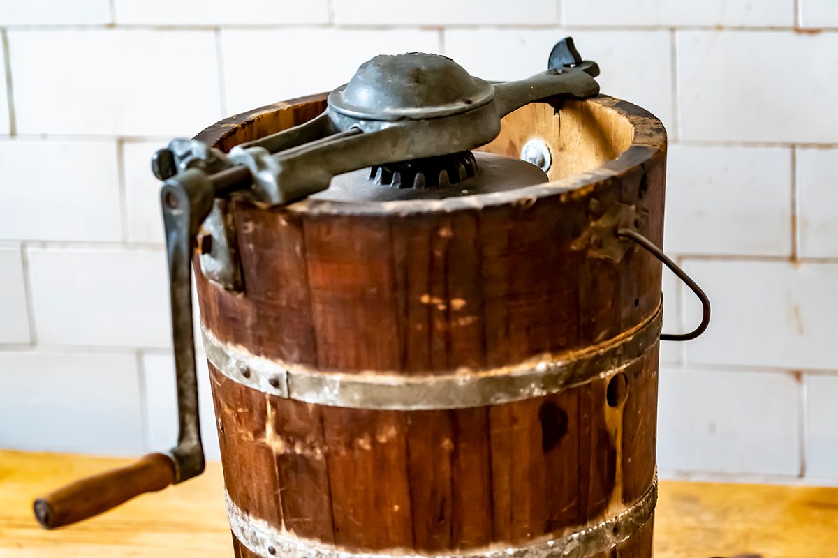 An Old Fashioned Ice Cream Maker With Turning Handle And Makers Mark