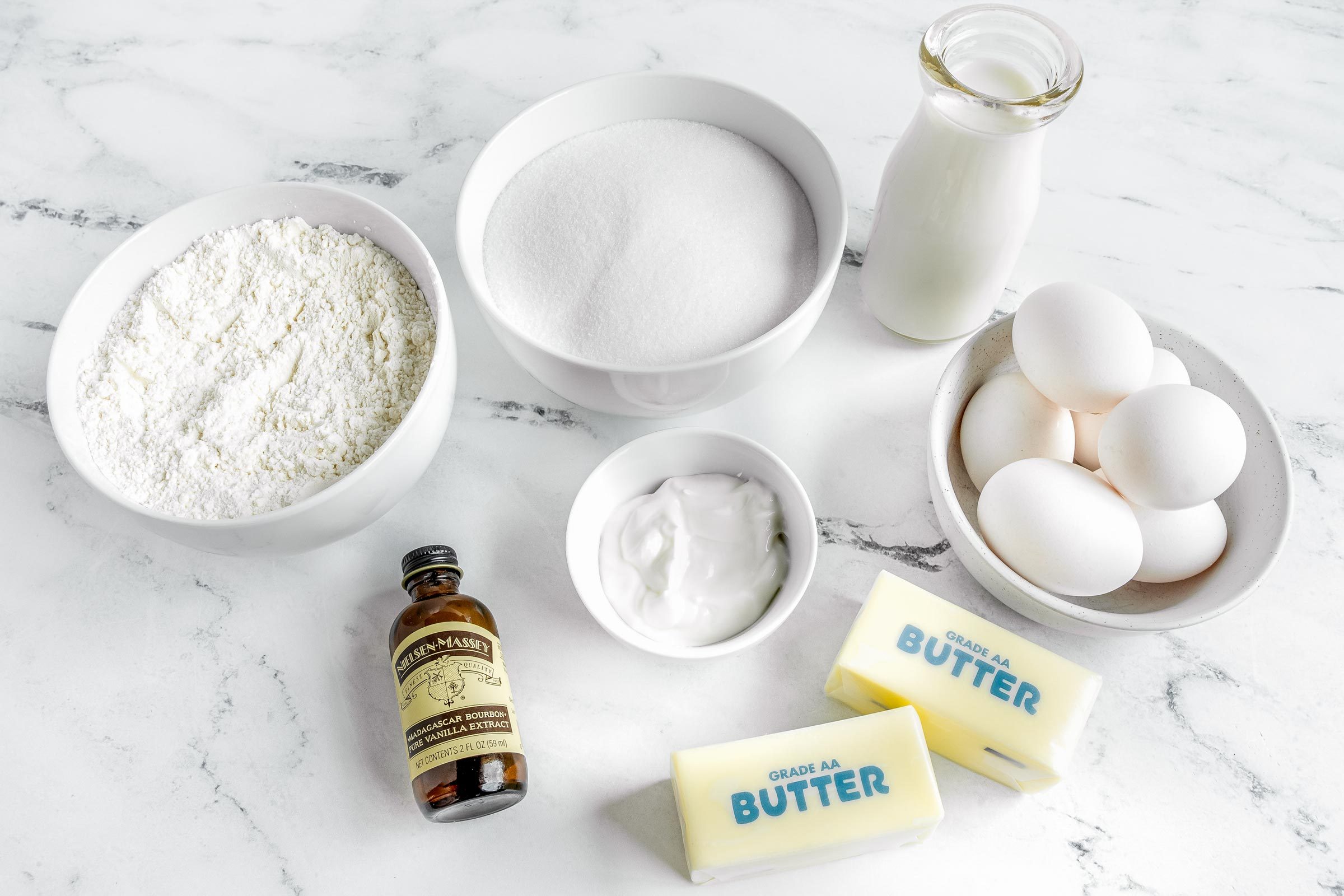 Cold Oven Pound Cake Ingredients layed out on a marble kitchen countertop