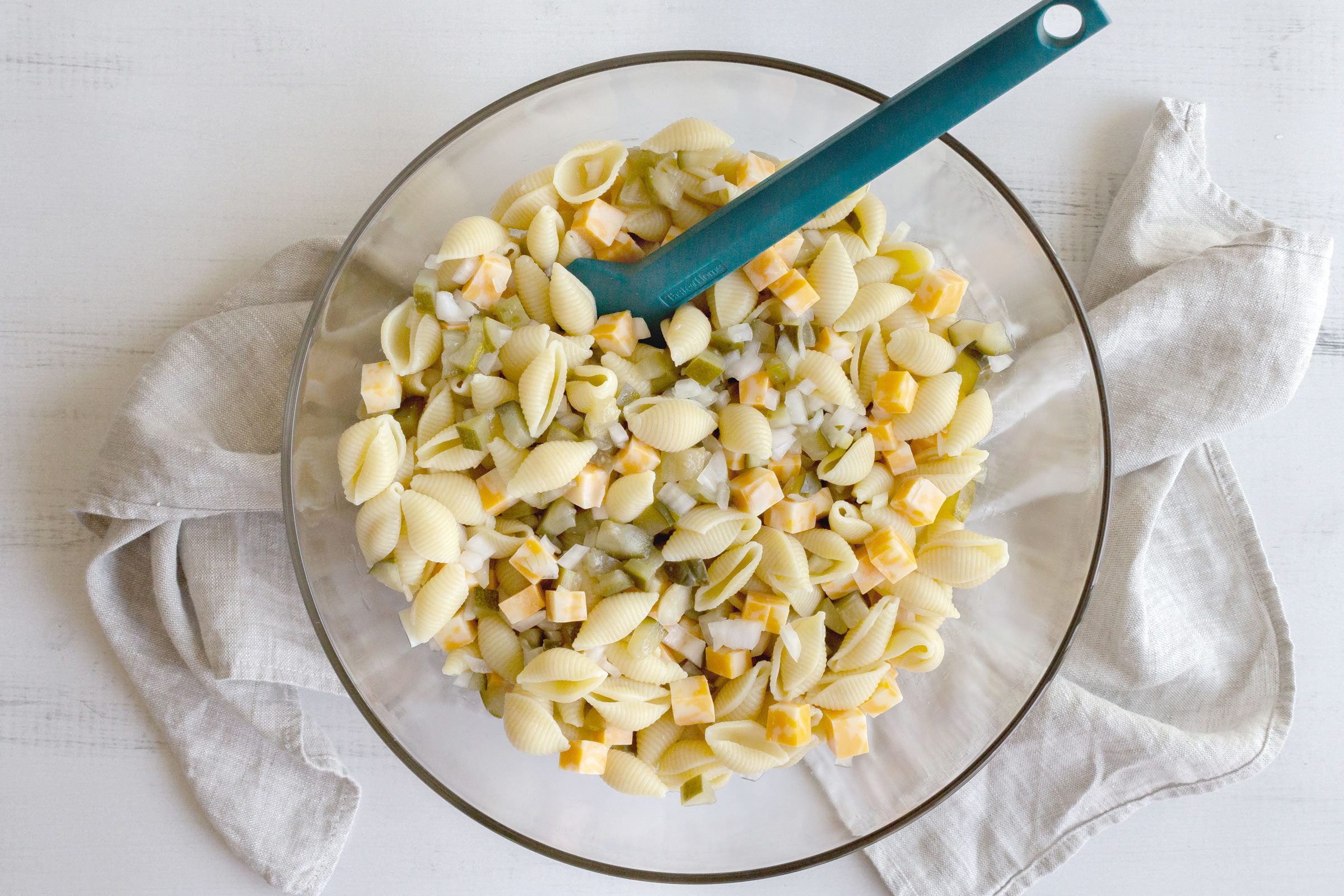pasta salad in a large glass bowl, view from above