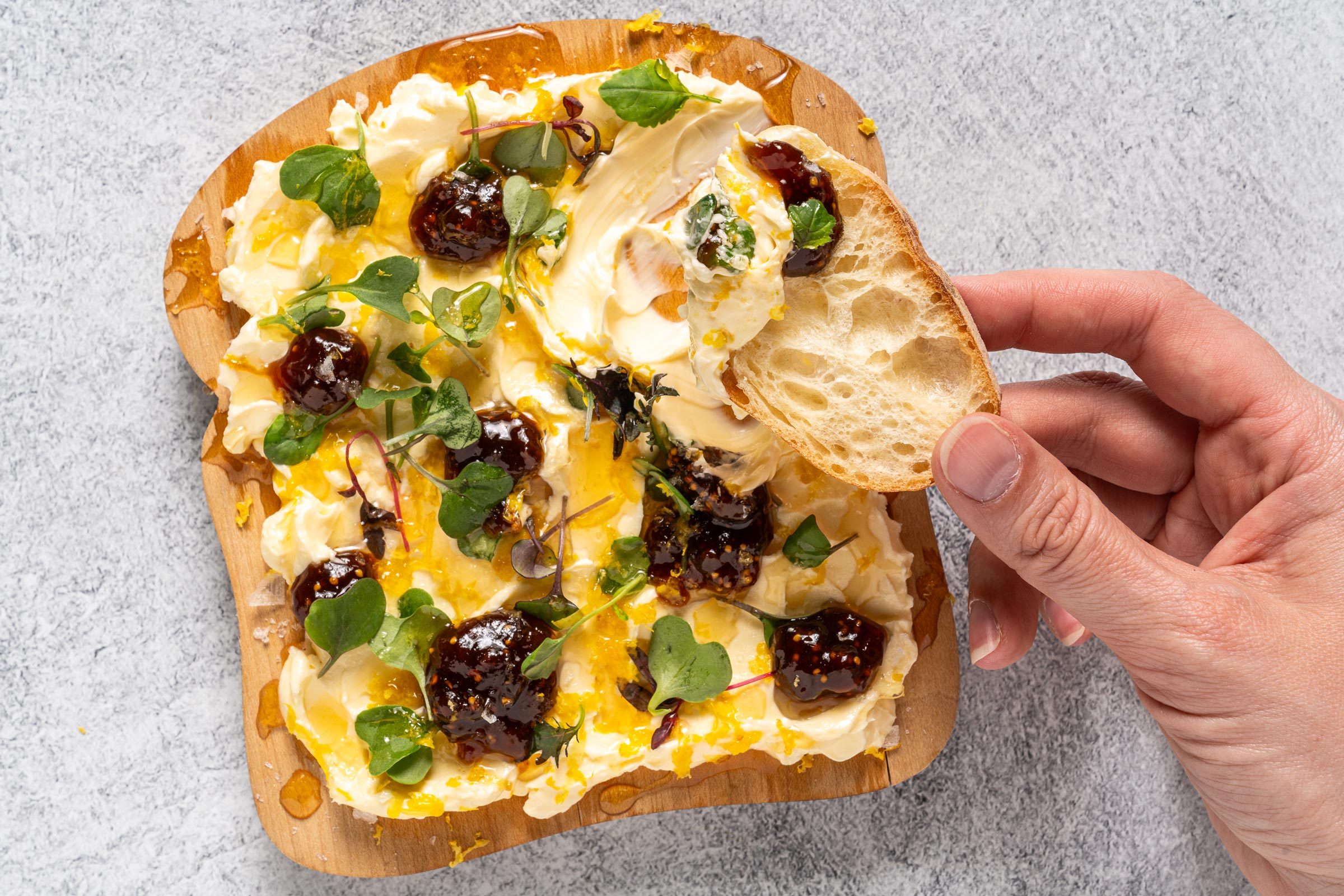 dipping bread in a butter board