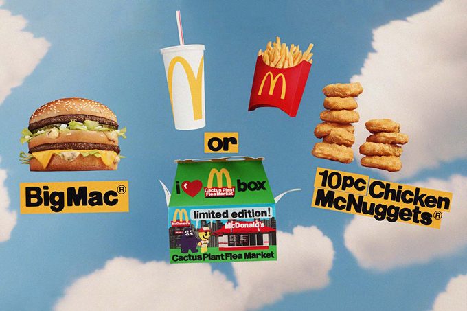 McDonald's adult happy meal with Big Mac, drink, fries and chicken nuggets on a vintage blue sky with clouds background