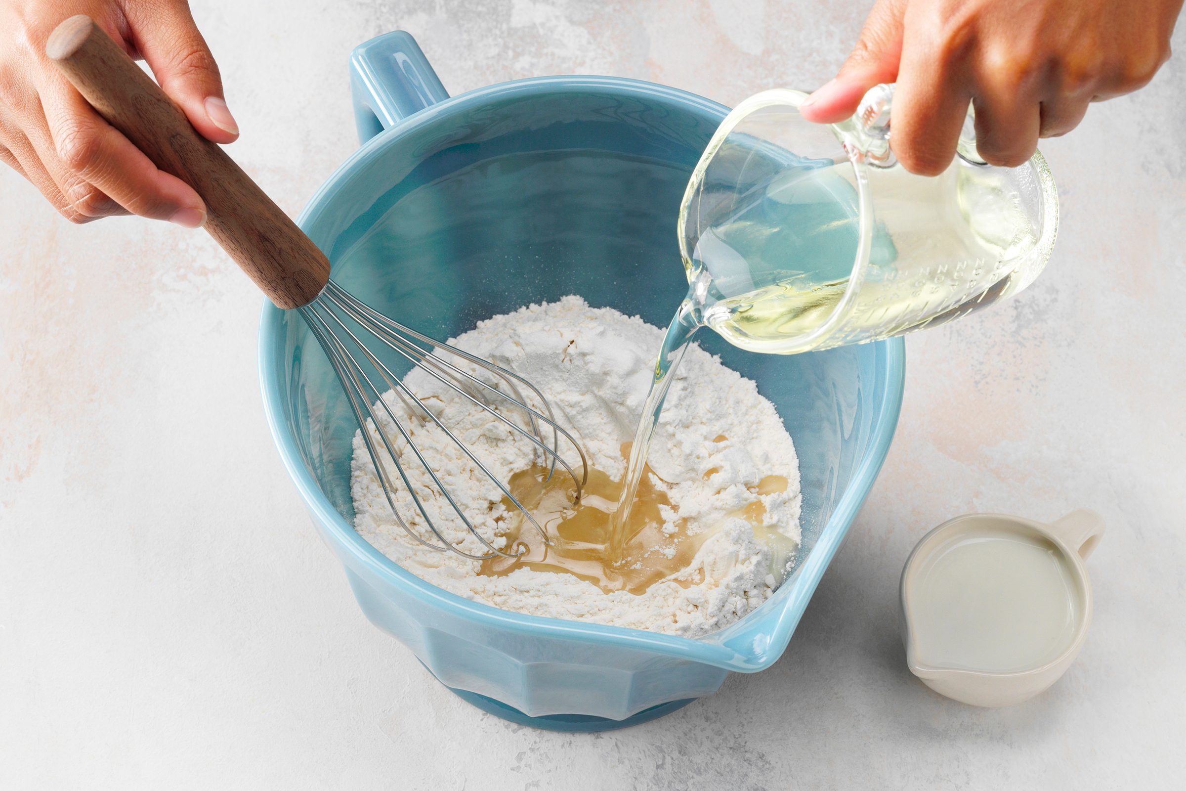 How To Make an Oil Pie Crust featuring Taste of Home's Easy No-Roll Pie Pastry recipe; step 2 of 4; Stir oil and milk into dry mixture