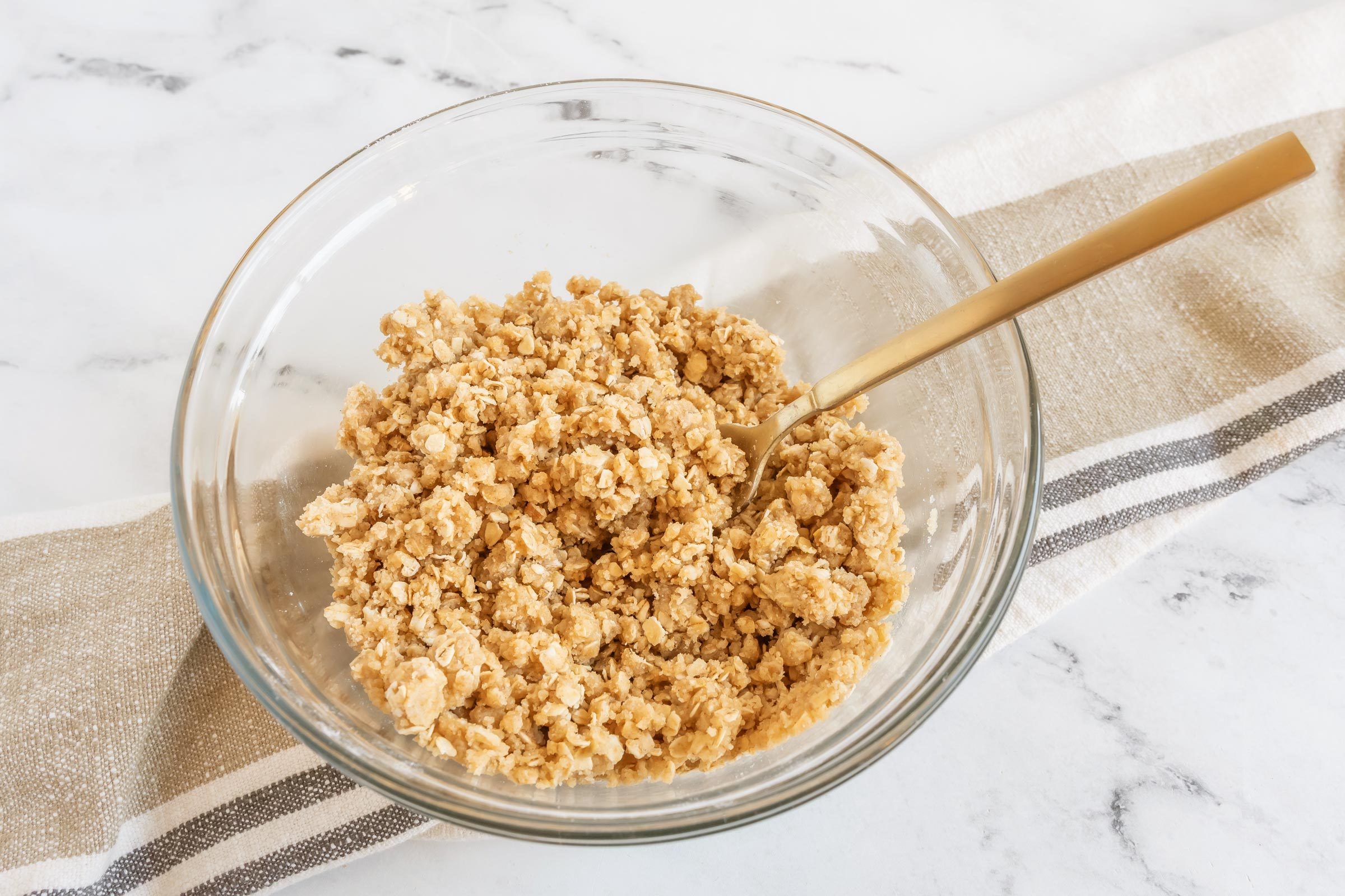 a clear glass bowl with amish apple goodie topping