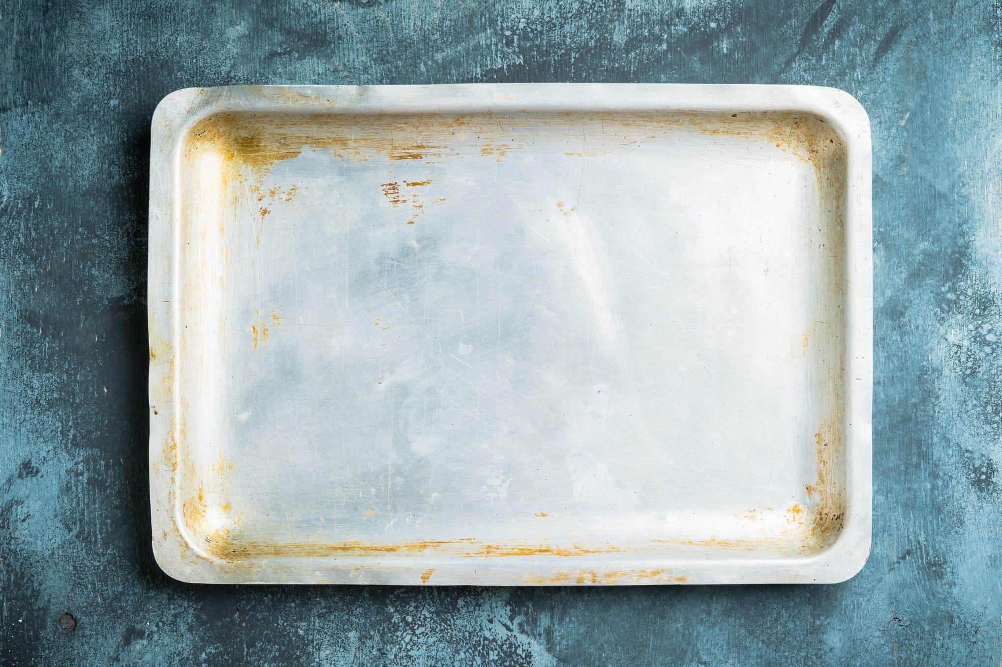 Clean baking sheet on the rustic background