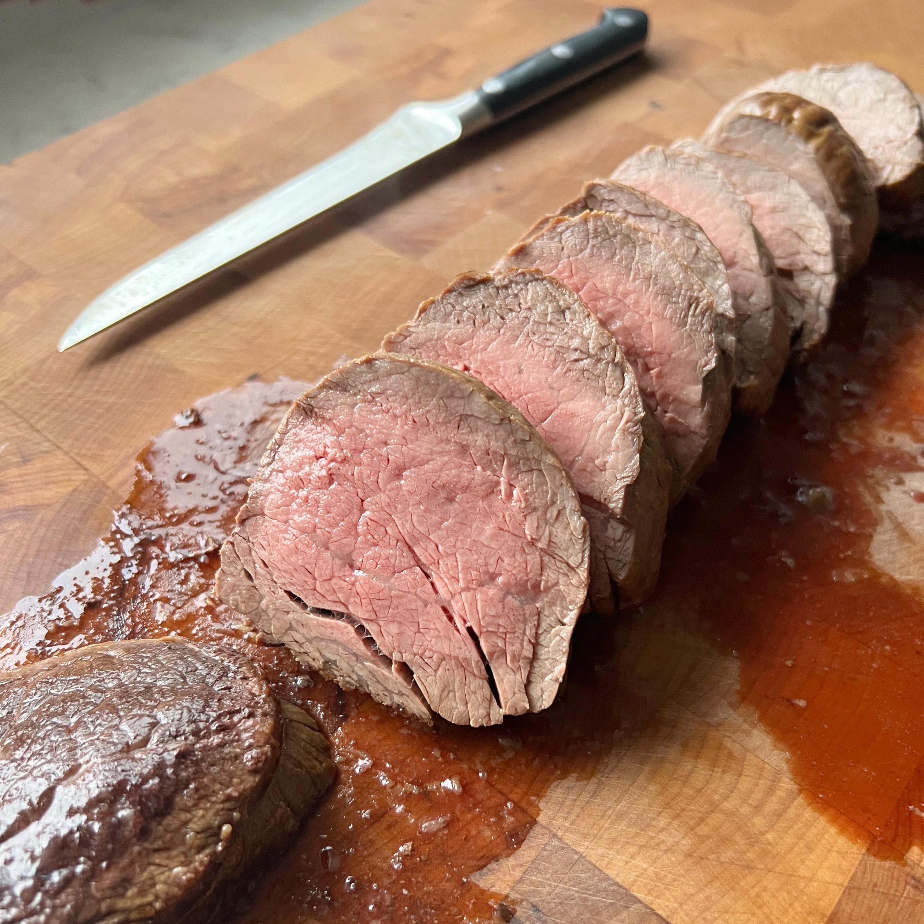 Ina Garten Beef Tenderloin cut up on a cutting board