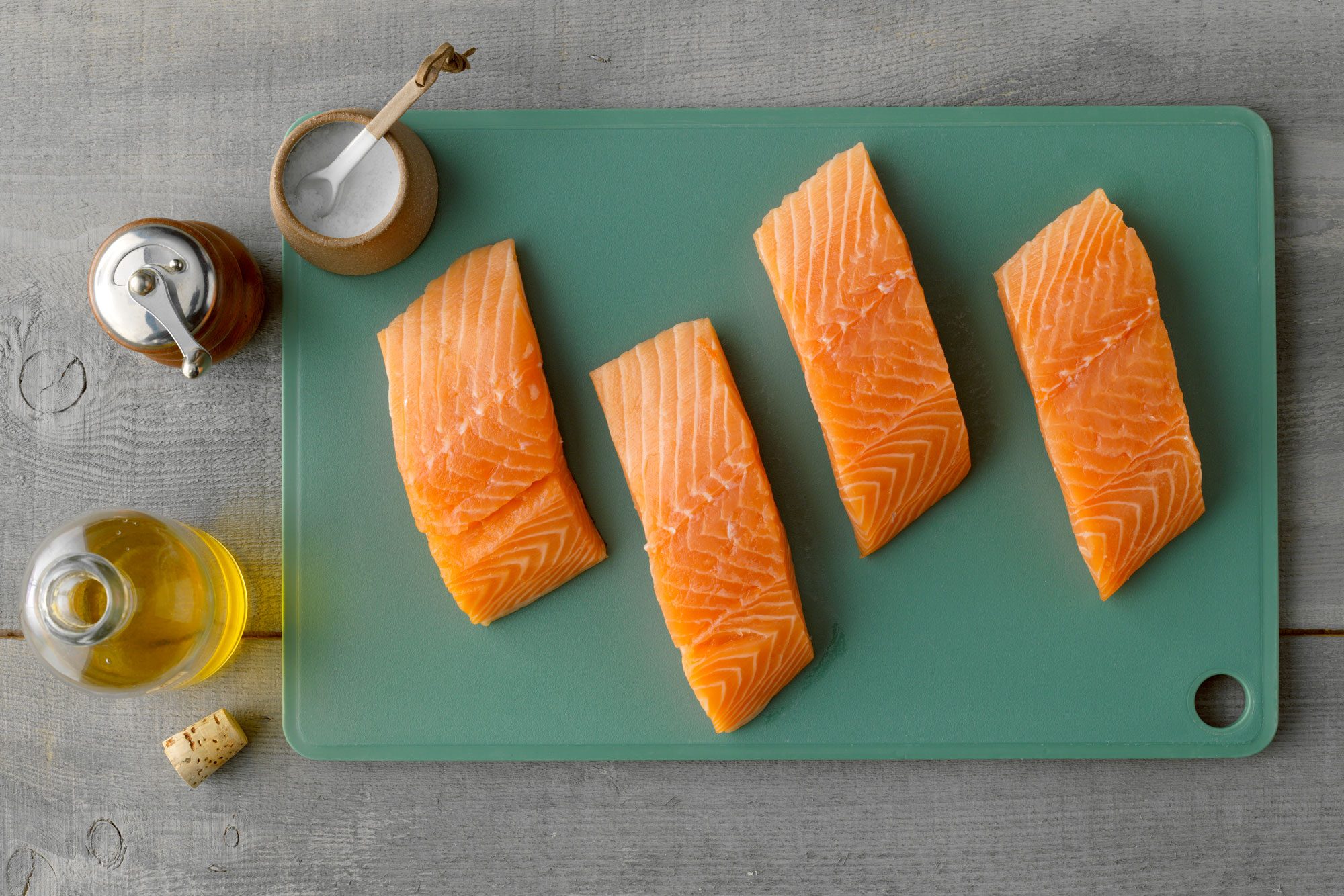 Overhead Shot Of All Ingredients for pan fried salmon On The gray wood surface