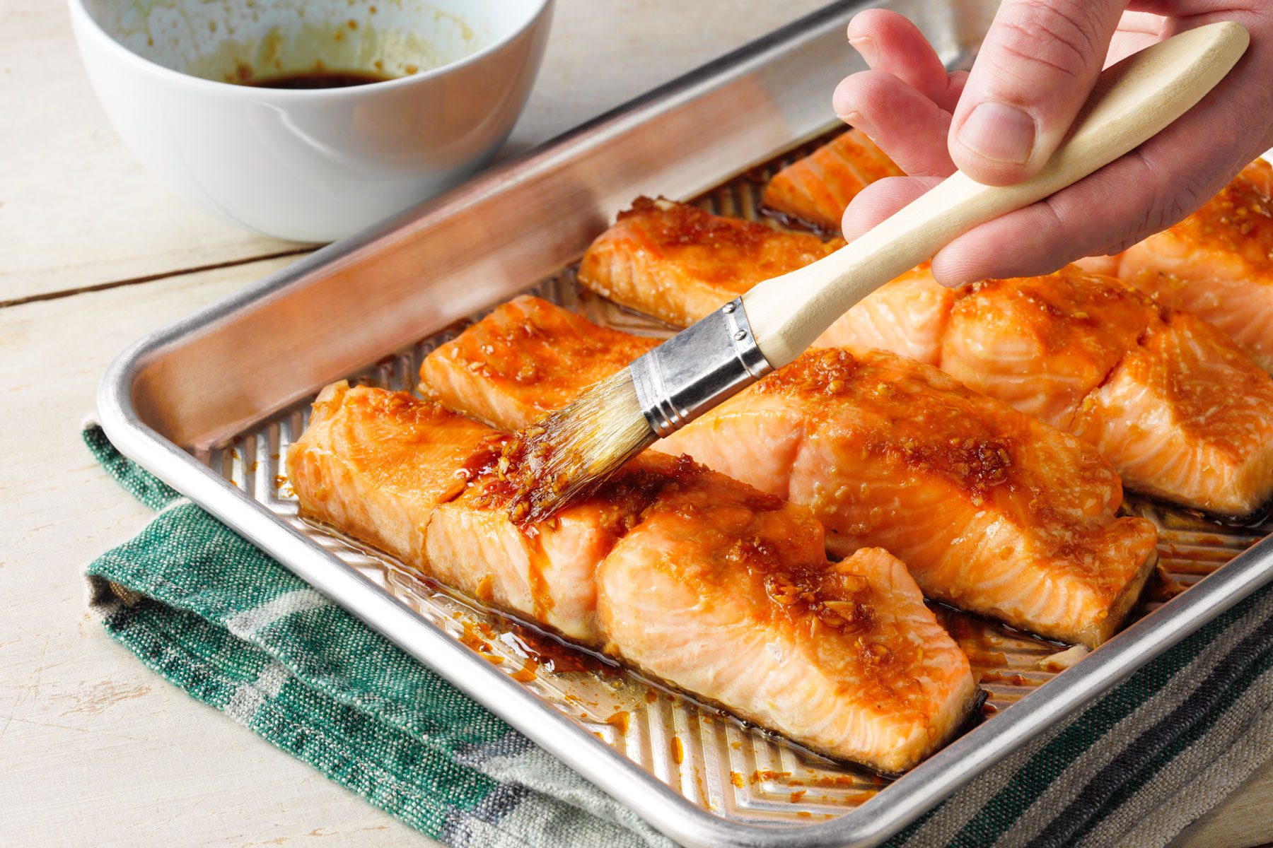 A Person Holding a Brush Over Food