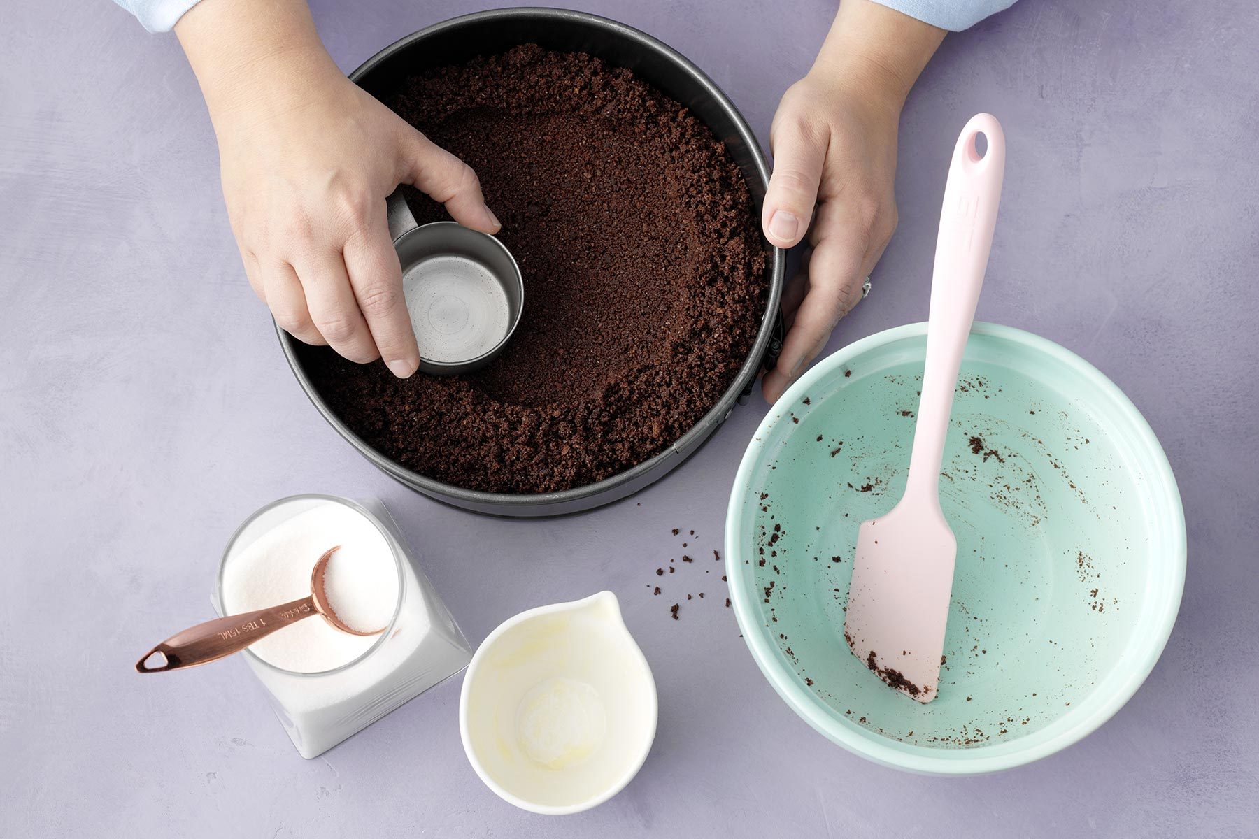 A Person Crushing Chocolate Mixture in a Bowl