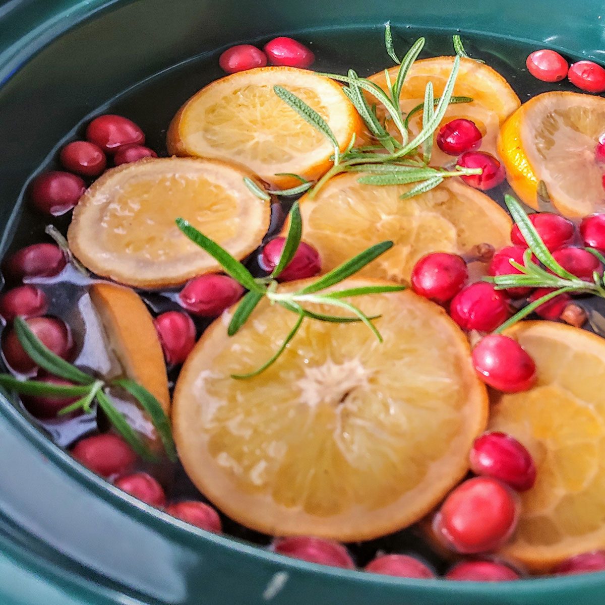 Christmas Crockpot with Cranberries, cinnamon, cloves, rosemary, oranges and nutmeg