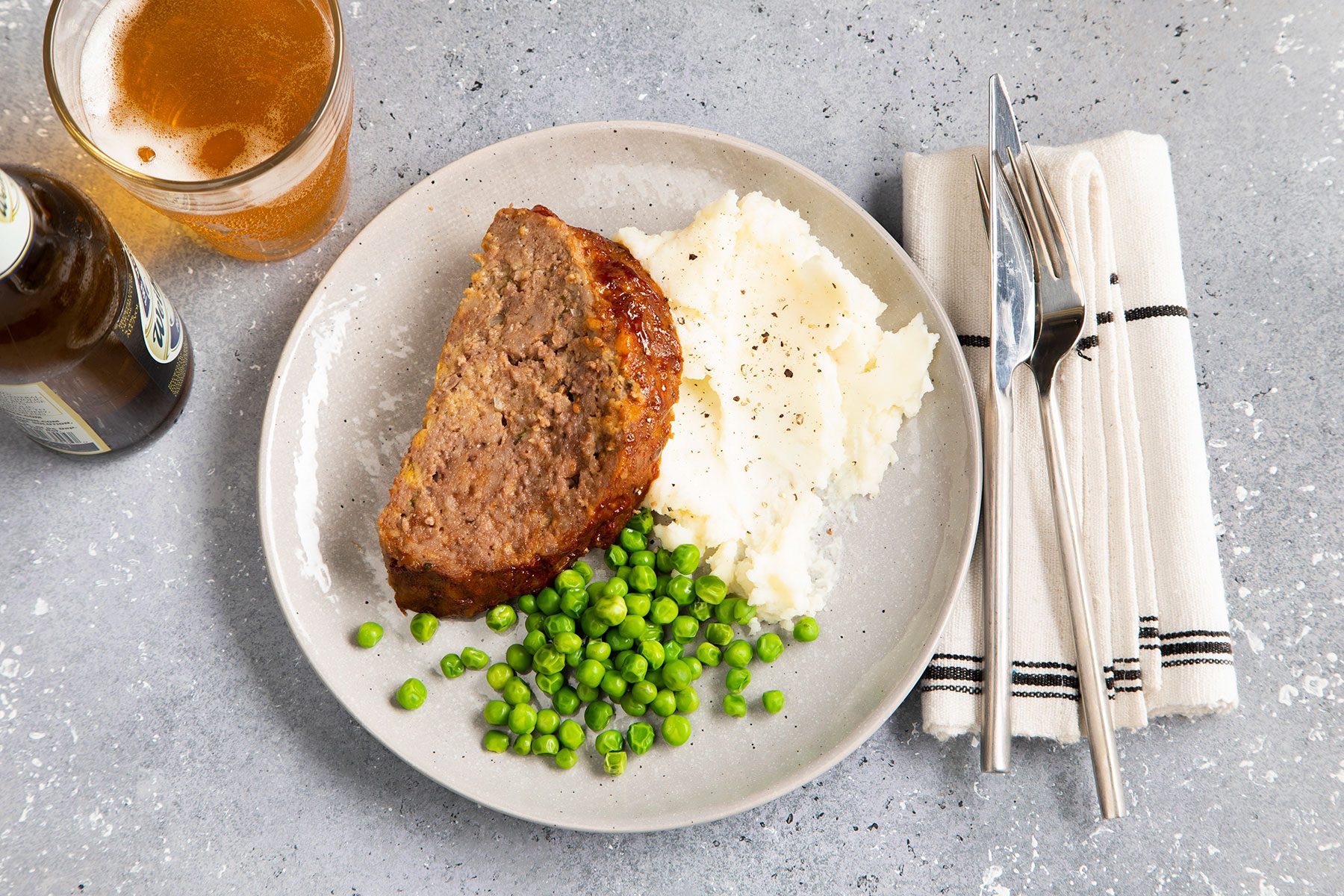 Instant Pot Meat Loaf with Mashed Potatoes and Peas and a drink 