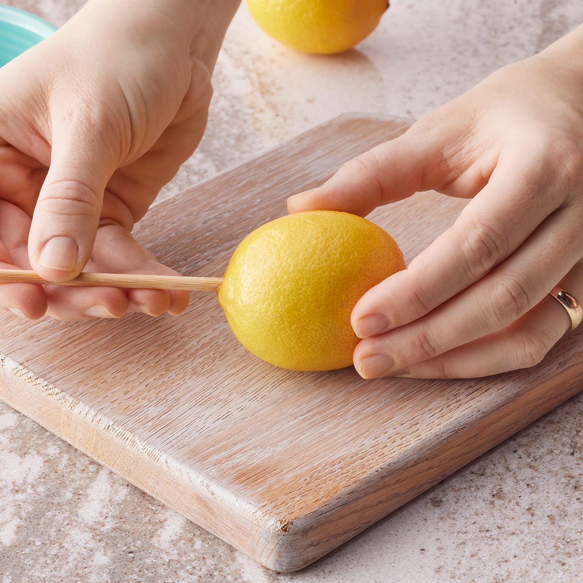 Putting hole in lemon 