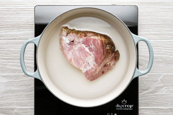 Ham bone in a large dutch over half filled with water