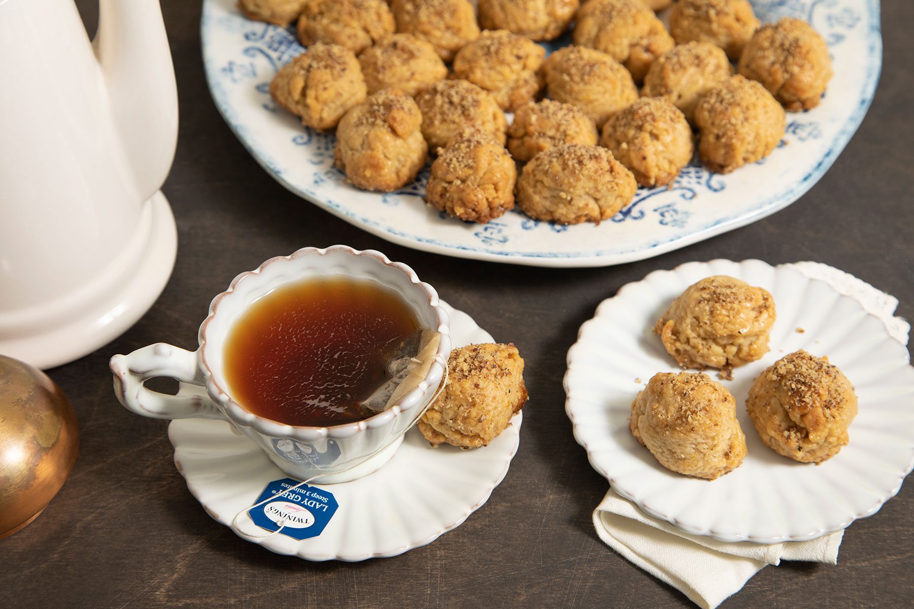 Melomakarona on plate and cup of tea