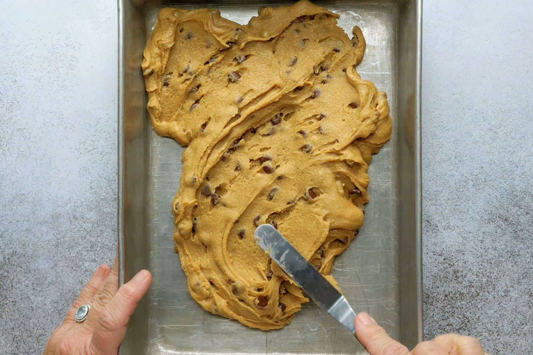 Spreading the dough in pan
