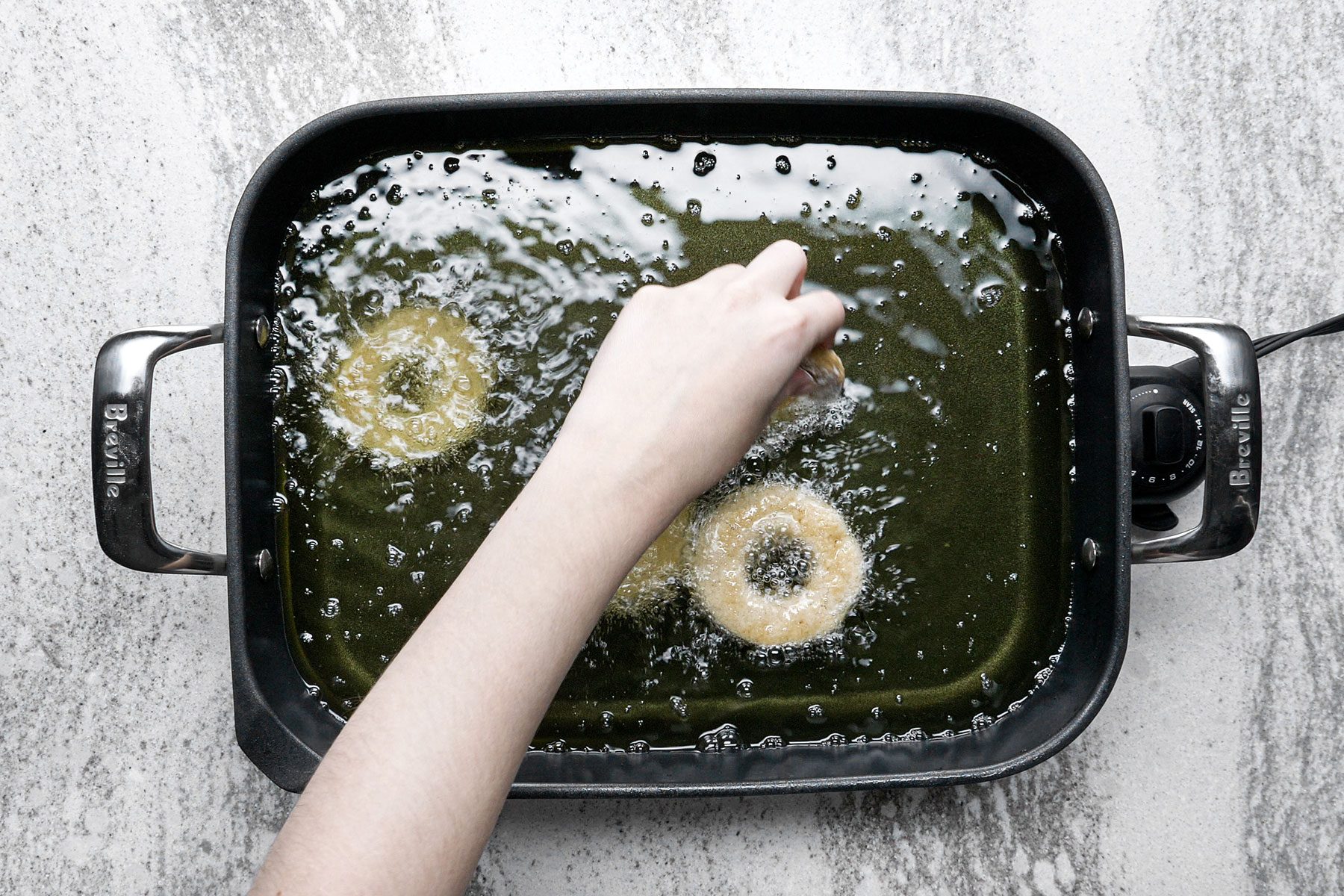 Frying the doughnuts in skillet