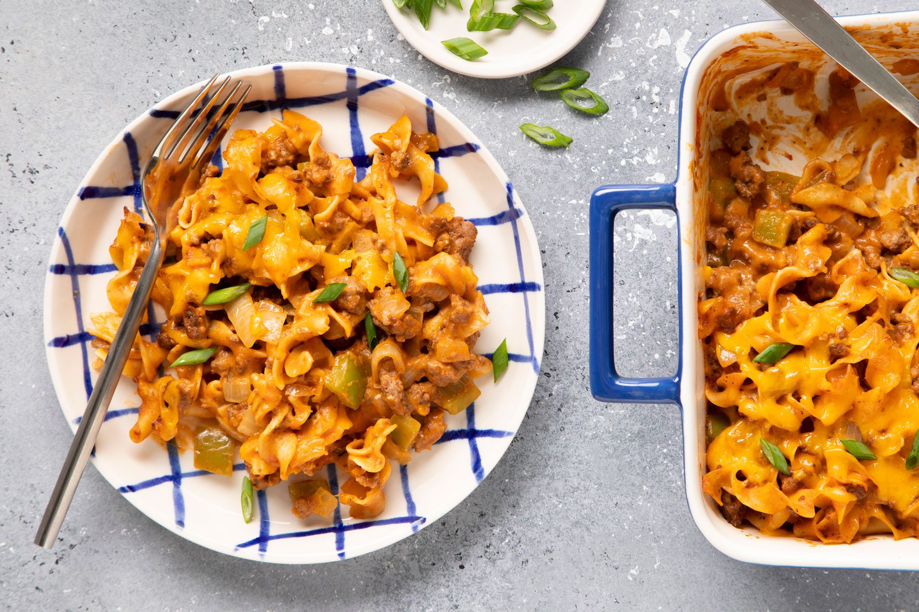 Beef And Noodle Casserole in a plate and a baking tray on a table