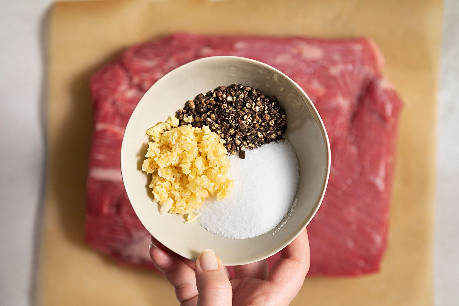 salt with sugar, crushed peppercorns and garlic in a small bowl