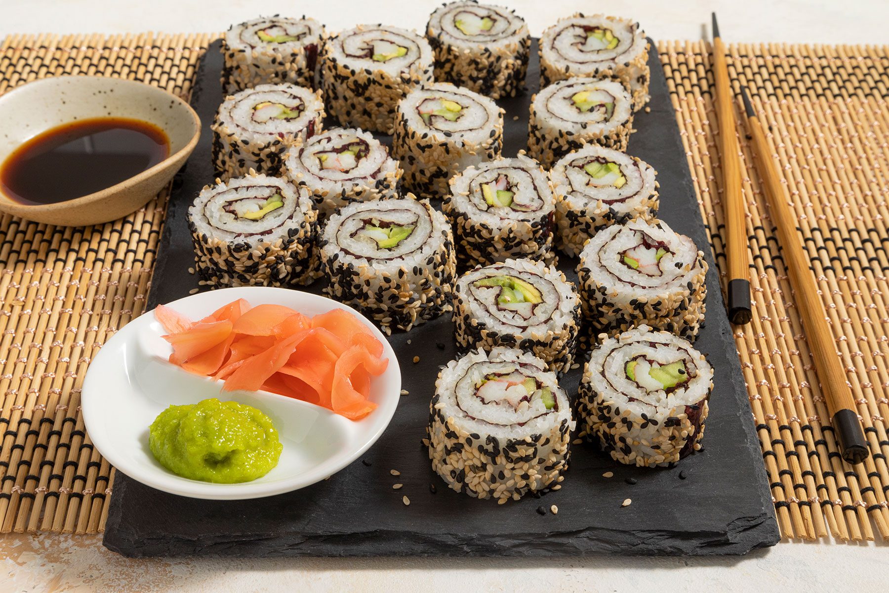 California Roll served with wasabi and soy sauce with chopsticks 