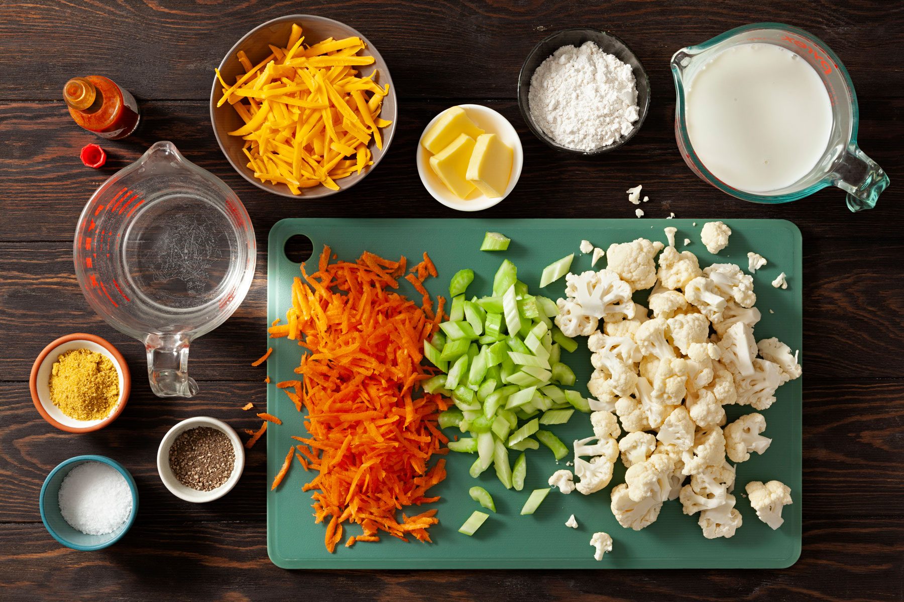 Vegetables cheese chicken and other ingredients on a table