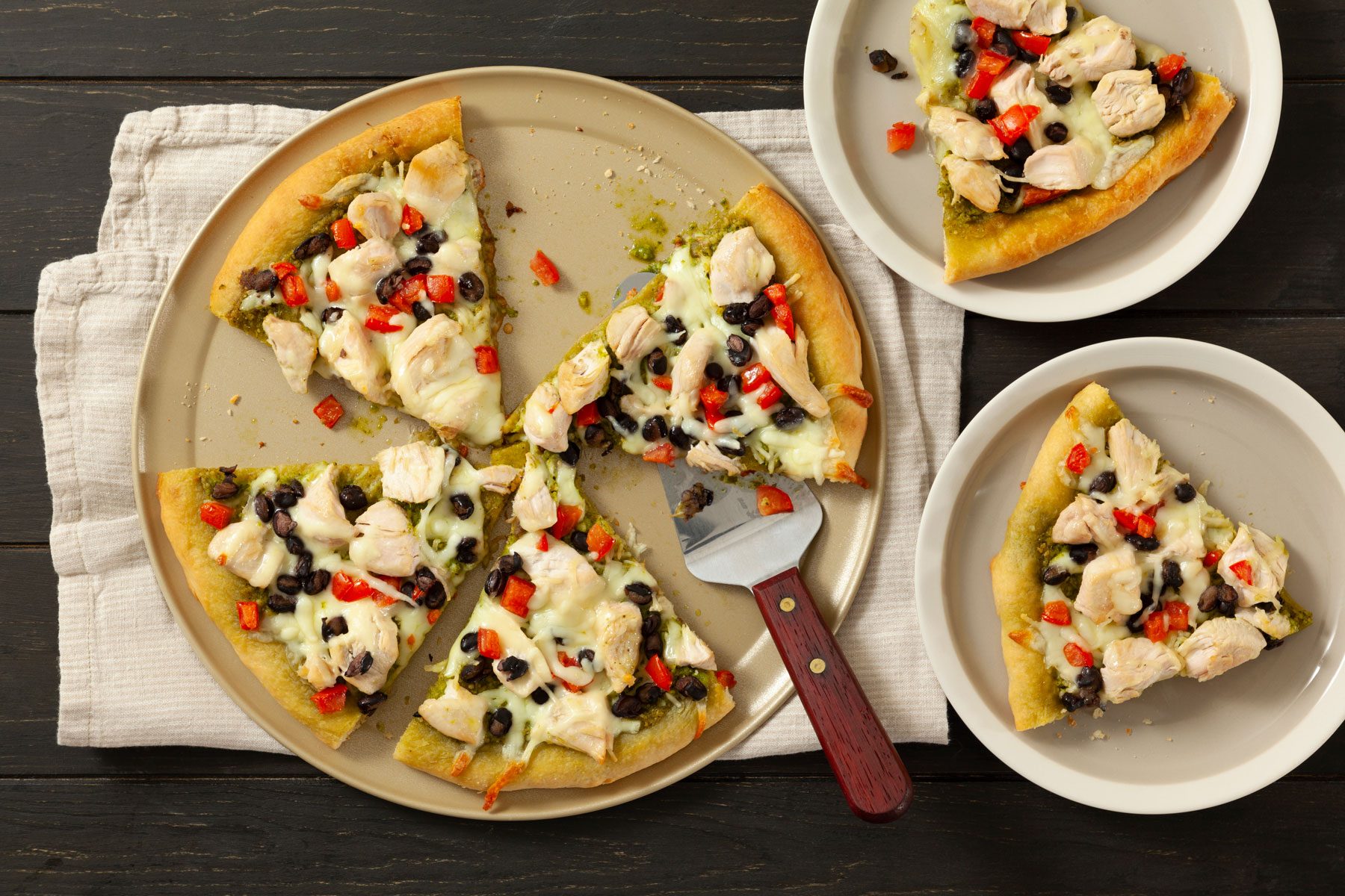 Chicken Pizza served in plates on a wooden surface