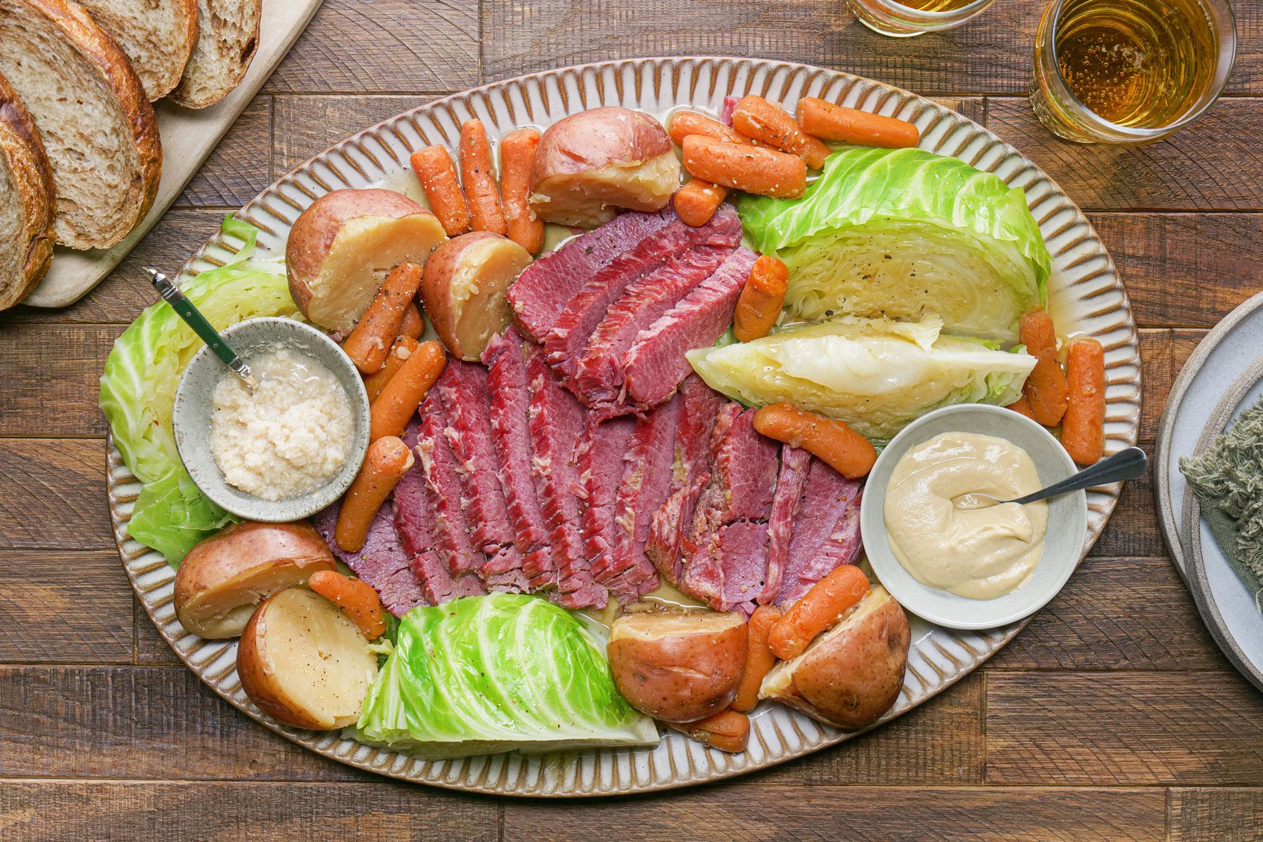 Corned Beef And Cabbage served in a plate with sauce in small bowls