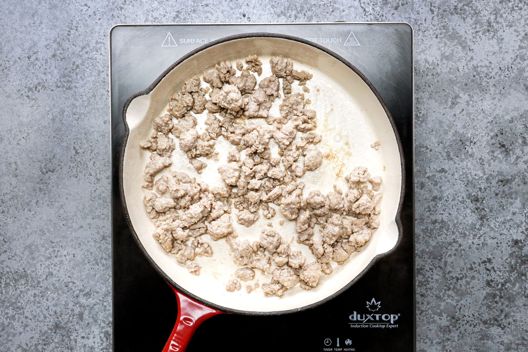 Cooking the sausage in a large skillet 