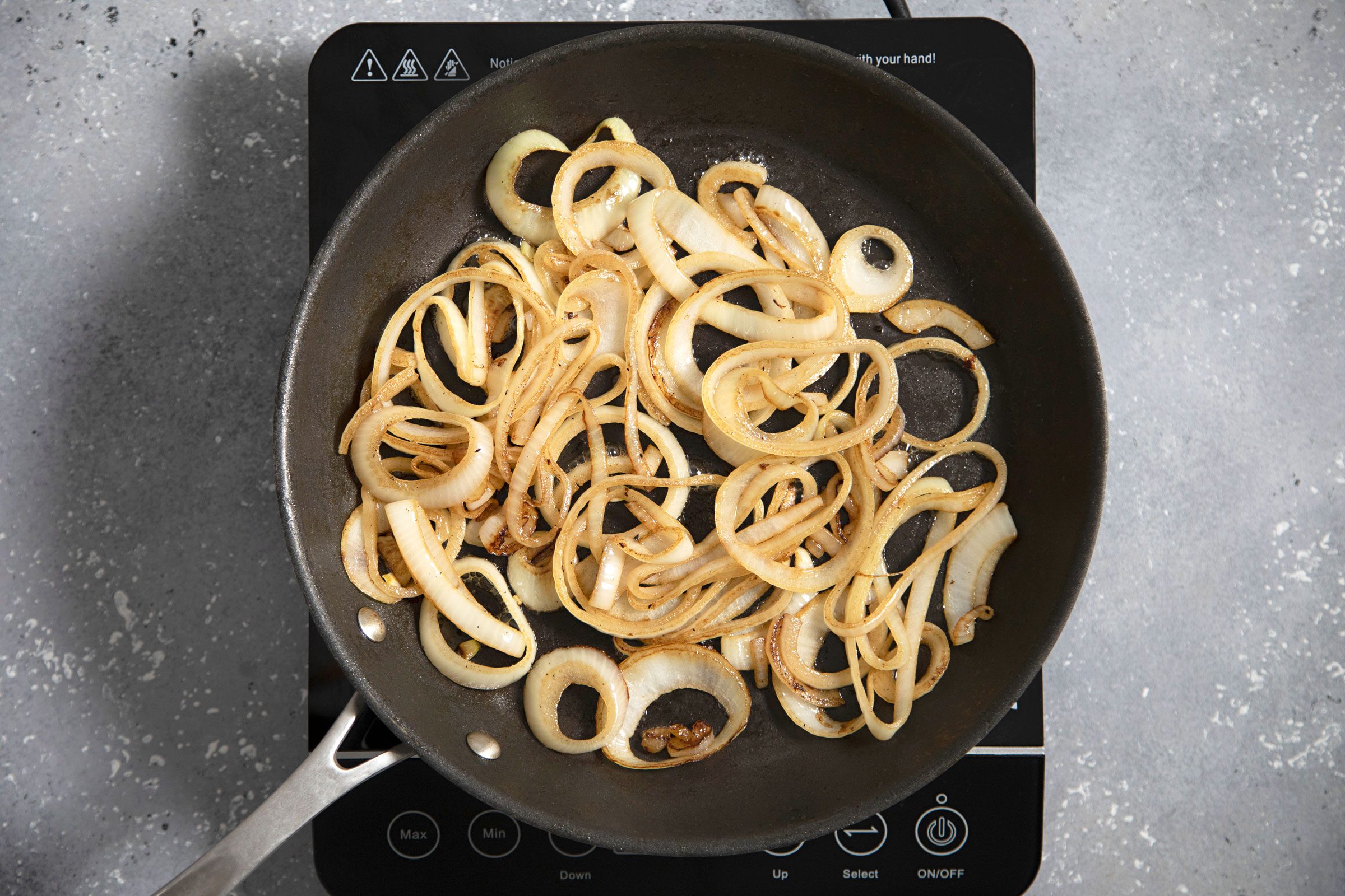 onions in a skillet on a hot plate