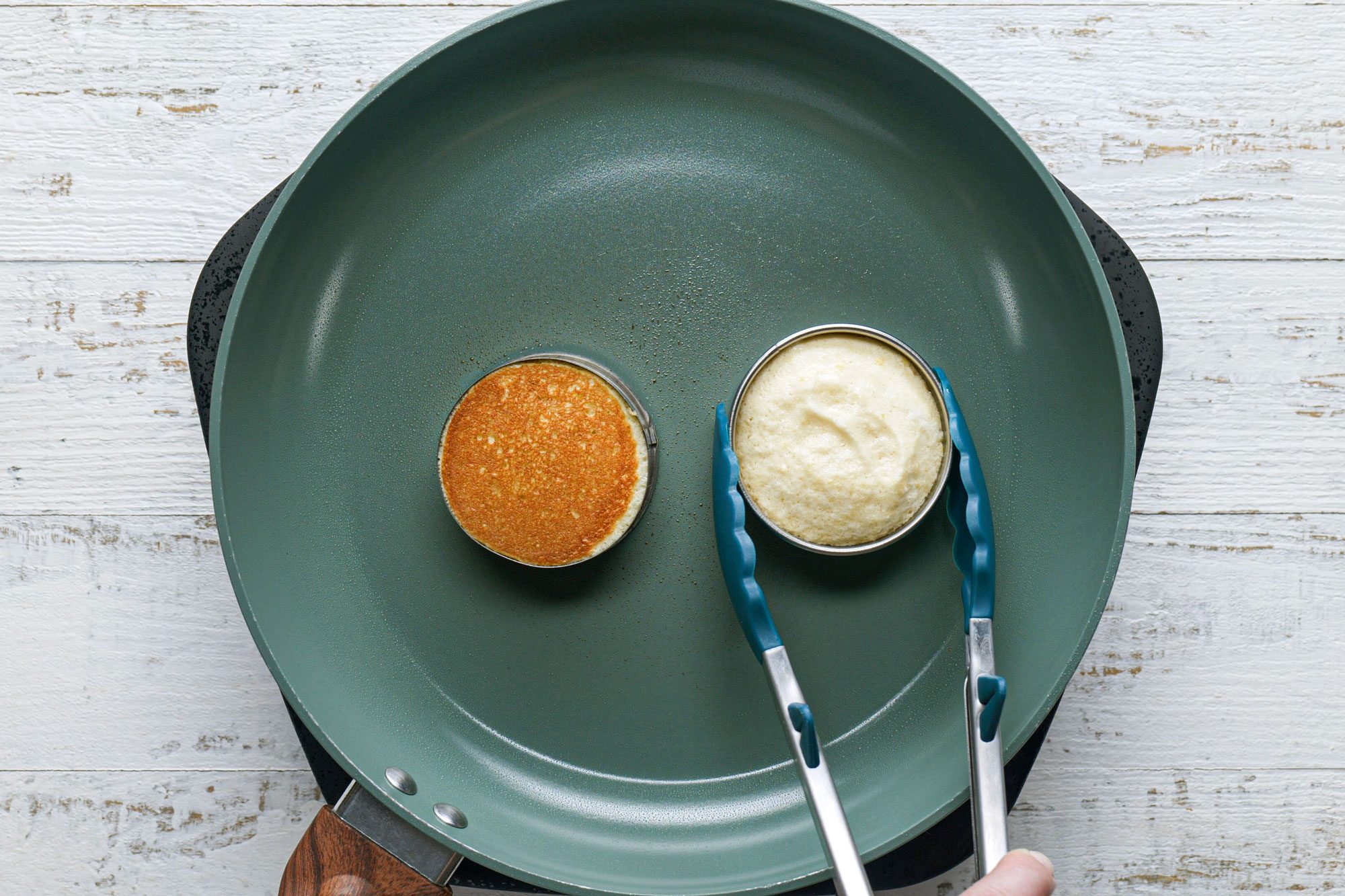 Cooking Japanese Pancakes In A Pan, White Painted Wooden Surface