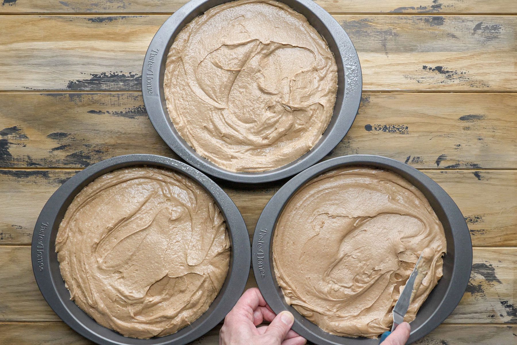 German Chocolate Cake batter in small pan on a wooden surface