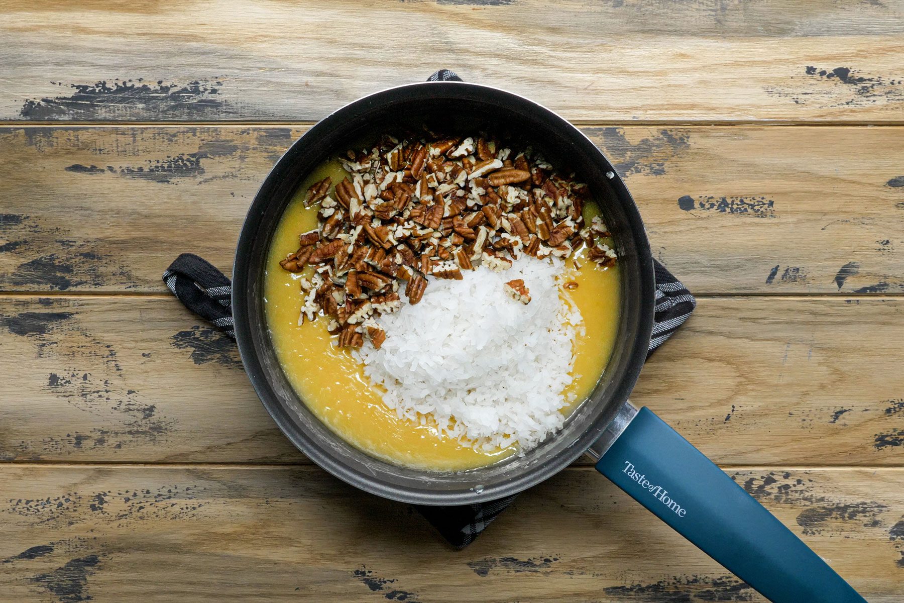 Coconut pecans added in eggs and milf mixture in a sauce pan