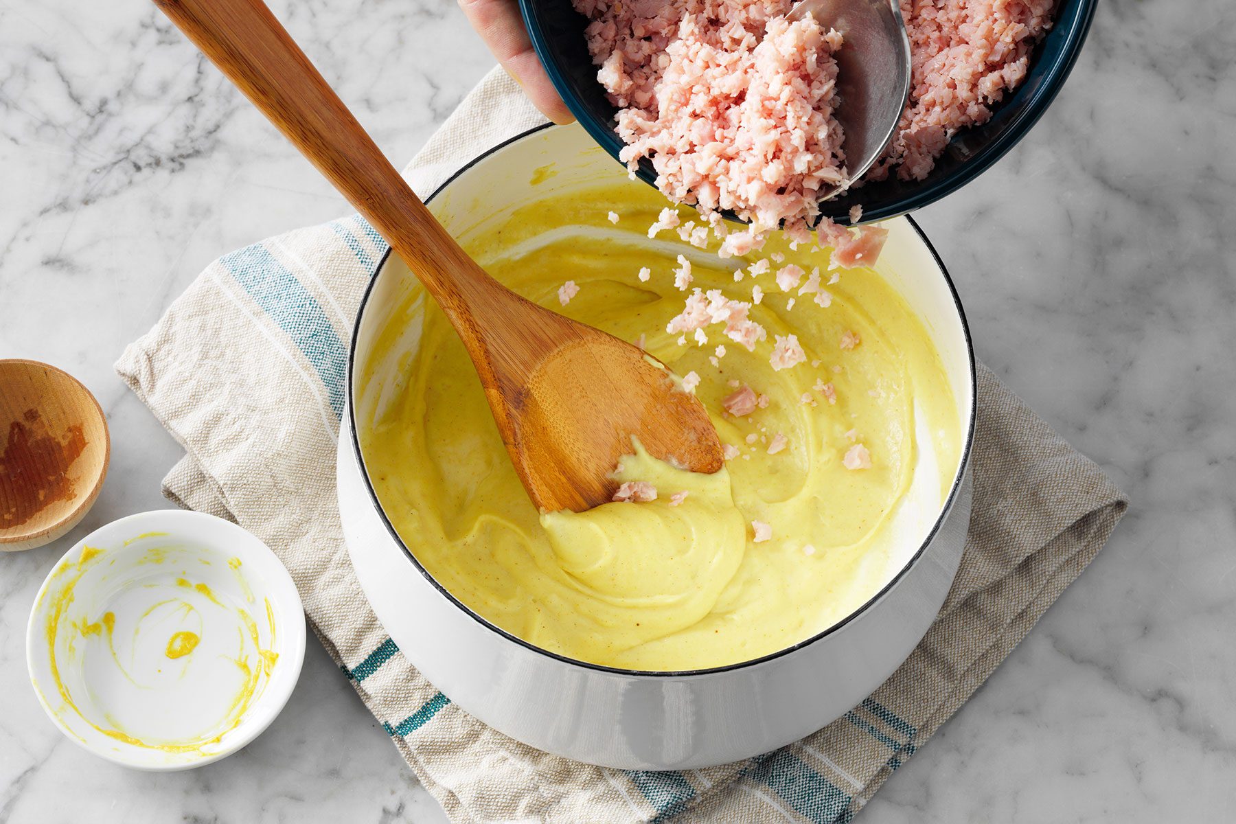 Adding grated ham in sauce