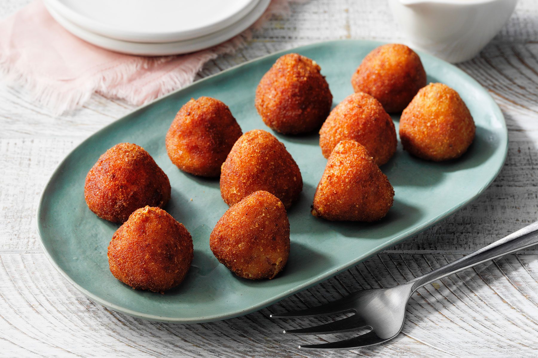 Ham Croquettes served on blue plate with fork on side